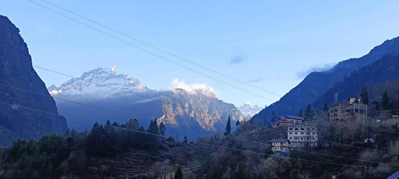 Wide real view across Lachung valley toward snow-touched Himalayan peaks