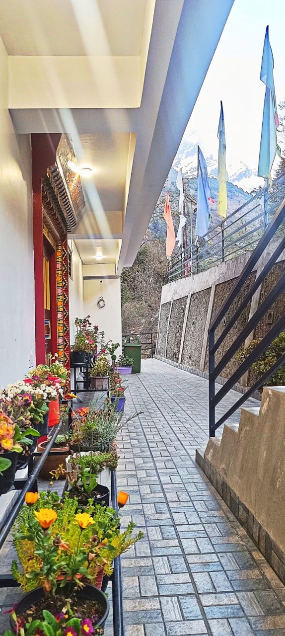 Flower-lined walkway and traditional entrance details at Floret Resort Lachung