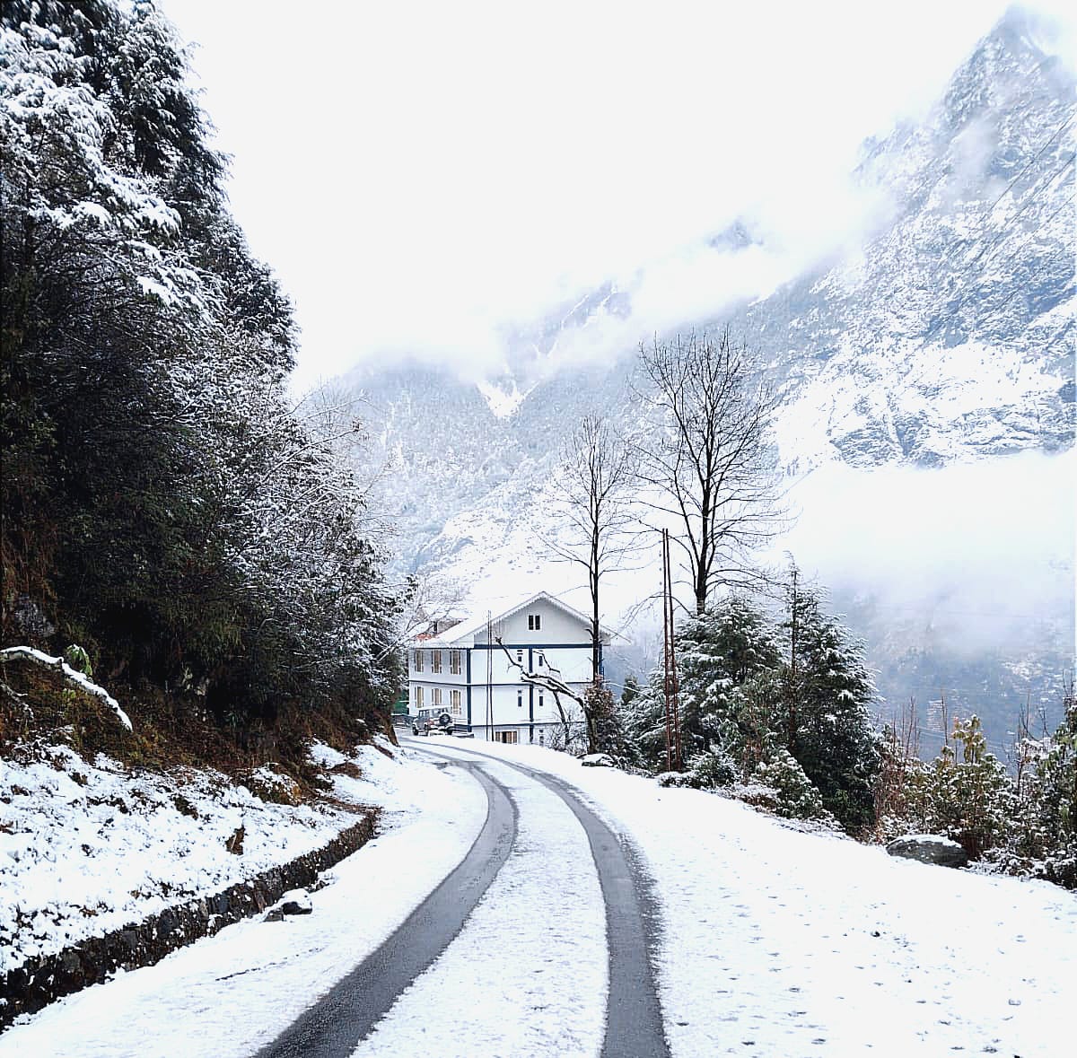 Snow-covered road leading to Floret Resort in Lachung, North Sikkim