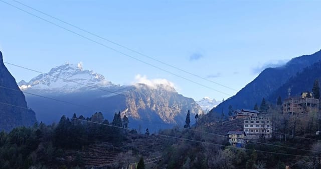 Wide view across the Lachung valley toward snow-touched Himalayan peaks