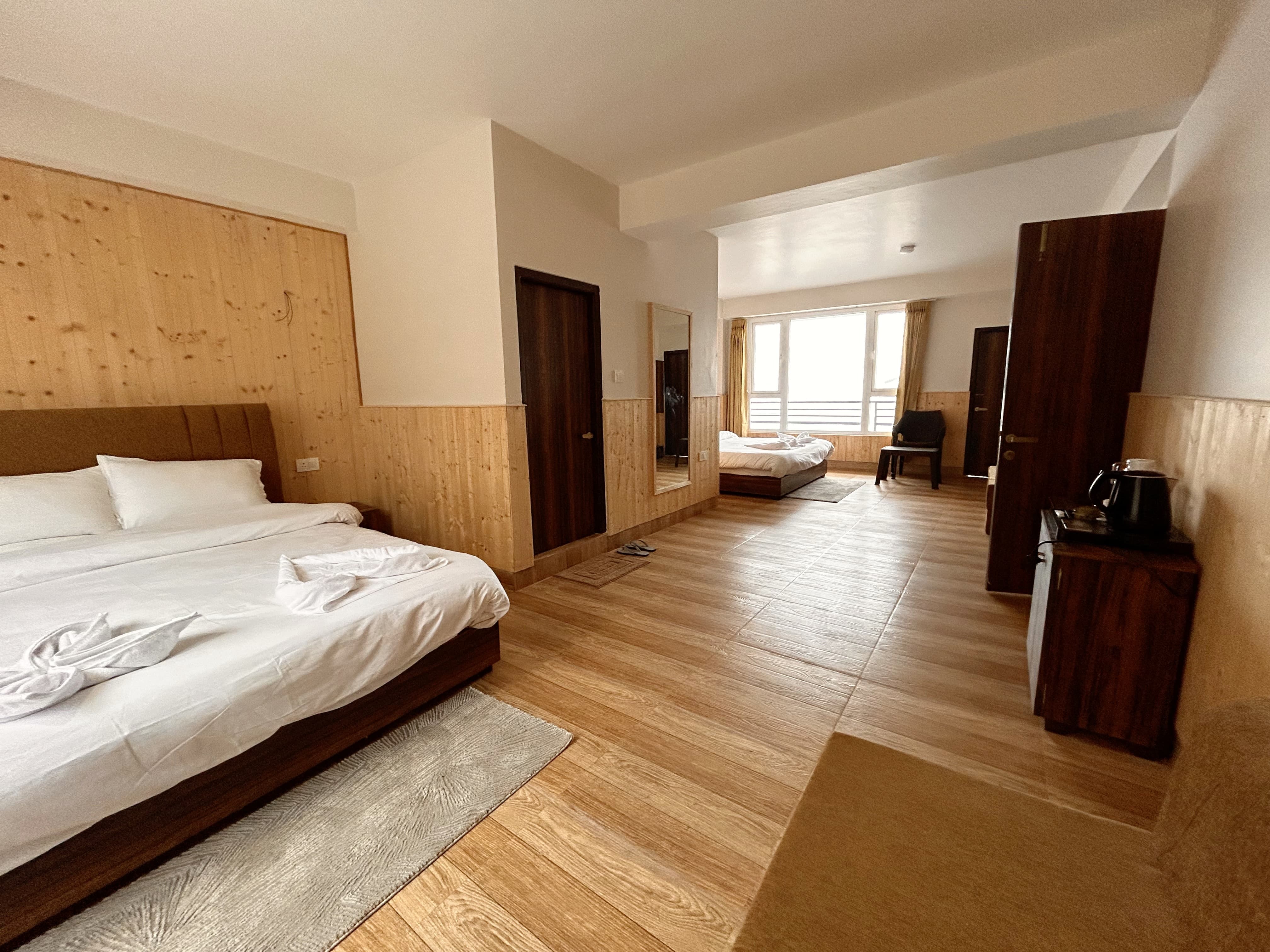 The family room seen end to end, with a wardrobe, a full-length mirror and a tea tray with an electric kettle